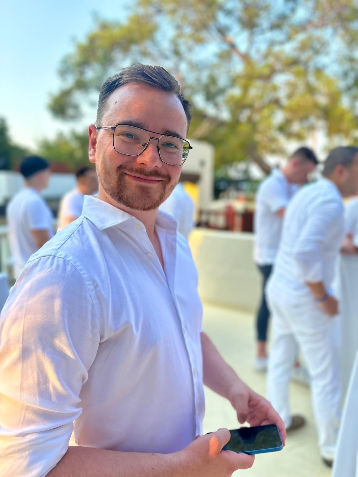 Rundes Foto von einem jungen Mann im Hemd, er lächelt